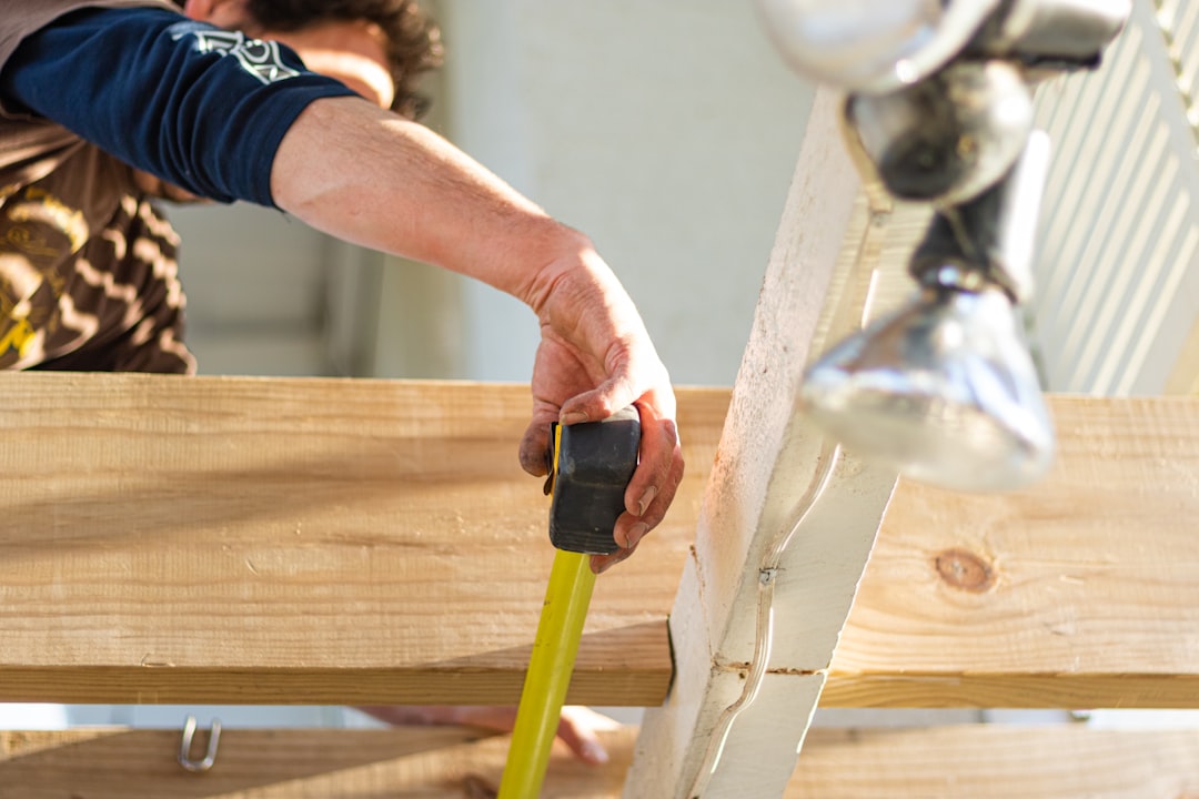 gallery-1 A builder measures out the gap between each beam