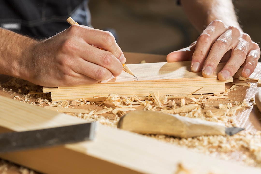 Young carpenter working with cutter in his studio